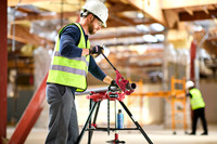 Construction worker cutting pipe